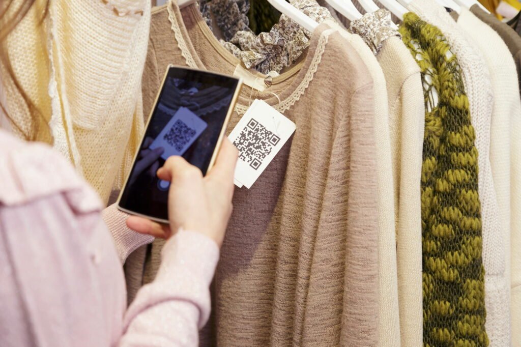 a customer taking a picture of a QR code in a clothing store